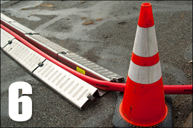 Lay at an angle to flow of traffic, so vehicles cross one wheel at a time.